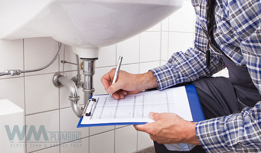 plumber in Doral diagnosing a clogged sink drain