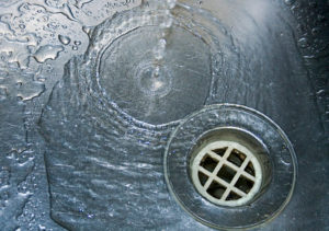 the link between drain clogs and poor water pressure: troubleshooting tips