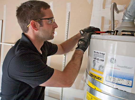 plumber in Doral, Florida repairs a leaky water heater